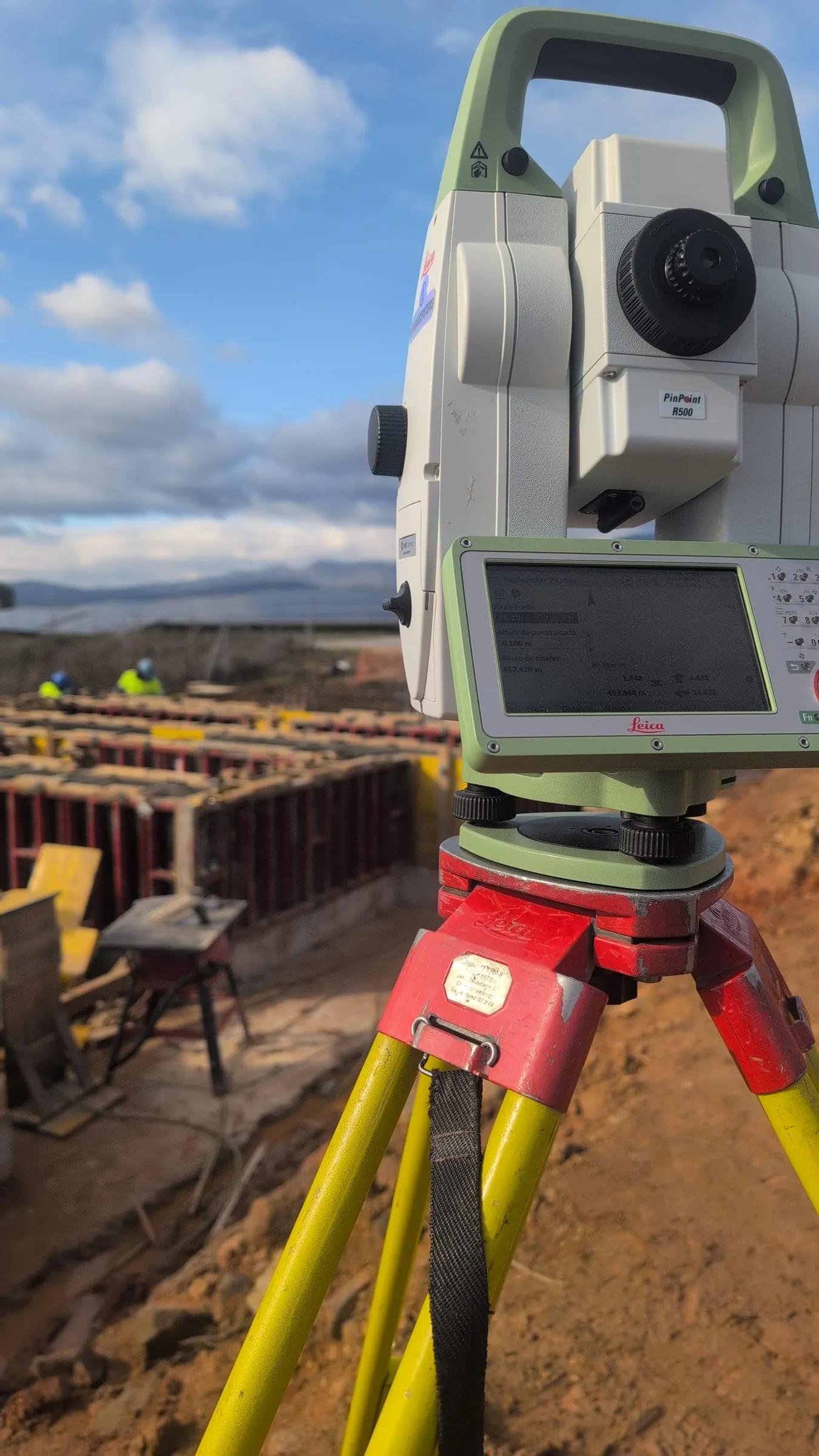 Total station on a tripod during foundation works at BESS Fundão Phase II